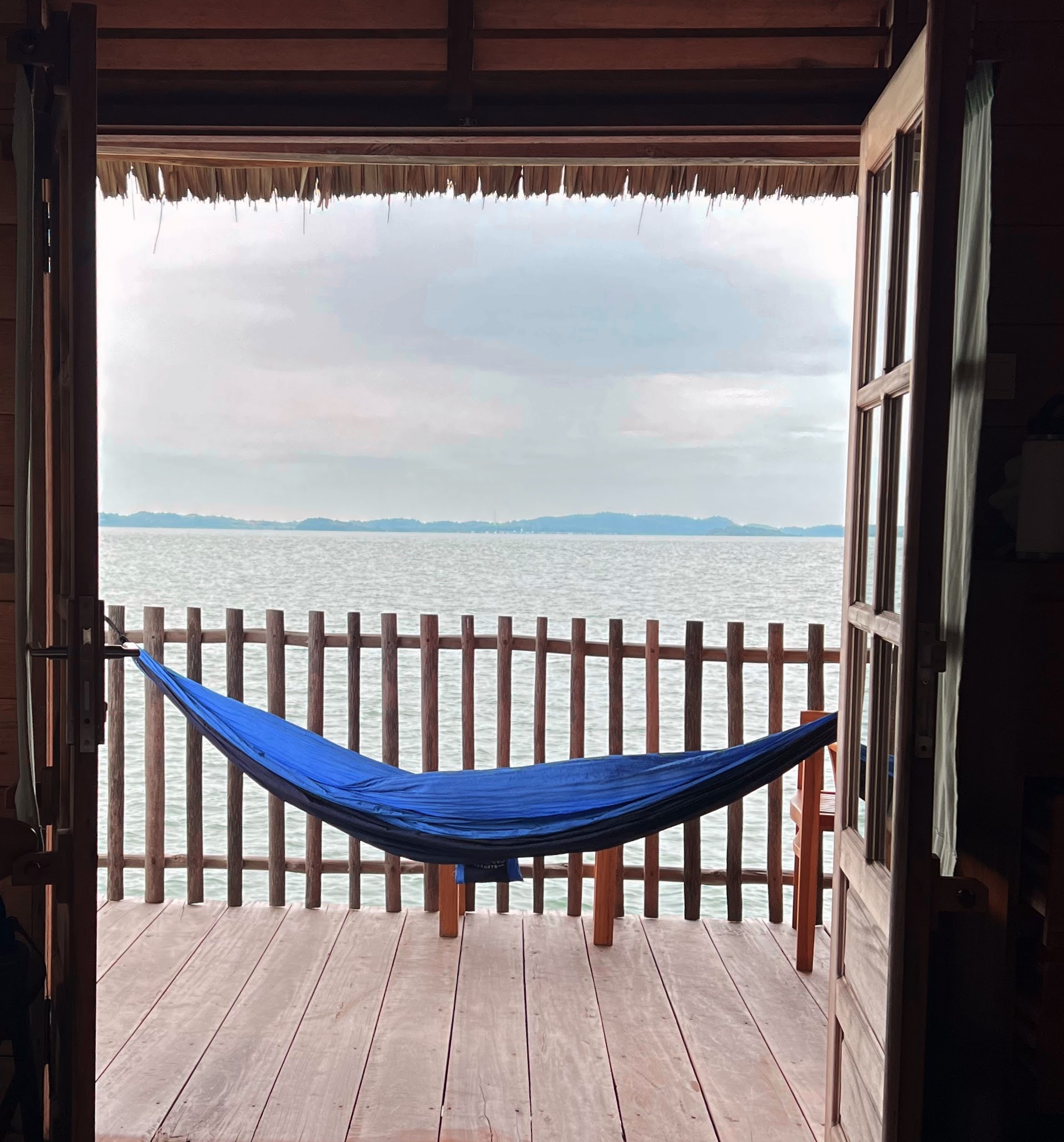 A relaxing hammock on a deck over the water, representing a Kasero getaway